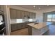 Modern kitchen with gray cabinets, quartz countertops, island with sink, and stainless appliances at 11422 E Utah Ave, Mesa, AZ 85212