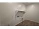 A practical laundry room with tile flooring, a shelf, and essential utility hookups awaits appliance installation at 11422 E Utah Ave, Mesa, AZ 85212