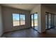 Light-filled living room with tile floors and sliding glass doors to the backyard at 11422 E Utah Ave, Mesa, AZ 85212