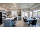 Modern kitchen with gray cabinets, a white countertop island, and a dining area with natural light at 1282 W Kesler Ln, Chandler, AZ 85224