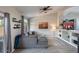 Cozy living room with a plush gray sofa, decorative shelves, and a sliding door to the outdoors at 1282 W Kesler Ln, Chandler, AZ 85224