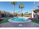 Backyard pool with lounge seating, desert landscaping, and covered patio at 1282 W Kesler Ln, Chandler, AZ 85224