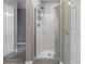 Modern walk-in shower with white tiled walls and a sleek glass enclosure, showcasing contemporary bathroom design at 1282 W Kesler Ln, Chandler, AZ 85224