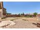 Large backyard featuring gravel landscaping, block fencing, and a patio area at 12825 W Virginia Ave, Avondale, AZ 85392