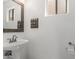 Bright bathroom featuring a pedestal sink and a framed mirror at 12825 W Virginia Ave, Avondale, AZ 85392