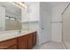 Bathroom with a sink vanity, mirror, and a shower-tub combo at 12825 W Virginia Ave, Avondale, AZ 85392