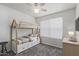 Bedroom features a bunk bed with drawers, a bedside table and a large window at 12825 W Virginia Ave, Avondale, AZ 85392