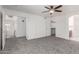 Large bedroom with a ceiling fan and multiple doors at 12825 W Virginia Ave, Avondale, AZ 85392