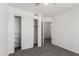A bright bedroom with a neutral color palette, plush carpet, and a spacious closet at 12825 W Virginia Ave, Avondale, AZ 85392
