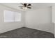 Carpeted bedroom featuring neutral walls and a ceiling fan at 12825 W Virginia Ave, Avondale, AZ 85392