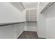 Walk-in closet featuring built-in shelving and carpeted flooring at 12825 W Virginia Ave, Avondale, AZ 85392