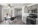 Eat-in kitchen features a dining table, grey cabinets, stainless steel appliances, and outside access at 12825 W Virginia Ave, Avondale, AZ 85392