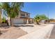 Charming two-story home with a well-maintained lawn, neutral colors, and a two car garage at 12825 W Virginia Ave, Avondale, AZ 85392