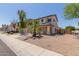 Two-story home with a well-maintained lawn, neutral colors, and a two car garage at 12825 W Virginia Ave, Avondale, AZ 85392