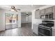Bright, modern kitchen with grey cabinets, stainless steel appliances, and backyard access at 12825 W Virginia Ave, Avondale, AZ 85392