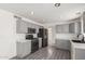 Modern kitchen featuring stainless steel appliances, grey cabinets, and laminate floors at 12825 W Virginia Ave, Avondale, AZ 85392