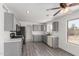 Updated kitchen with grey cabinets, stainless steel appliances, and laminate floors at 12825 W Virginia Ave, Avondale, AZ 85392