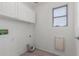Efficient laundry room with storage cabinets and plenty of room for appliances at 12825 W Virginia Ave, Avondale, AZ 85392