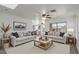 Bright living room featuring two sofas, a light wood coffee table and neutral walls at 12825 W Virginia Ave, Avondale, AZ 85392