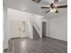 A brightly lit living room with sleek laminate floors, and an adjacent staircase at 12825 W Virginia Ave, Avondale, AZ 85392