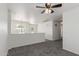An upstairs loft area with grey carpet and a ceiling fan at 12825 W Virginia Ave, Avondale, AZ 85392
