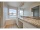 Bright bathroom features a granite vanity, soaking tub, and a large window offering serene outdoor views at 14623 N 90Th Ln, Peoria, AZ 85381