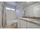 Neutral bathroom features a granite vanity, shower over tub combo, and modern fixtures at 14623 N 90Th Ln, Peoria, AZ 85381