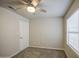 Neutral bedroom features carpet, a ceiling fan, and a window providing natural light at 14623 N 90Th Ln, Peoria, AZ 85381