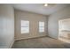 Bright bedroom features soft carpet, neutral walls, and access to an ensuite bathroom at 14623 N 90Th Ln, Peoria, AZ 85381