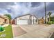 Charming single-story home with a well-manicured lawn and two-car garage at 14623 N 90Th Ln, Peoria, AZ 85381