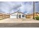 Attractive one-story house with a two-car garage and desert-style landscaping at 14623 N 90Th Ln, Peoria, AZ 85381