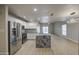 Modern kitchen with stainless steel appliances and granite island offers a stylish and functional space at 14623 N 90Th Ln, Peoria, AZ 85381