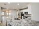 Stylish kitchen features a granite island and stainless steel appliances with a view to the entryway at 14623 N 90Th Ln, Peoria, AZ 85381