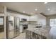 Contemporary kitchen with stainless appliances and an island is designed for culinary enthusiasts at 14623 N 90Th Ln, Peoria, AZ 85381