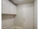 Laundry room features overhead cabinets and access to the exterior at 14623 N 90Th Ln, Peoria, AZ 85381