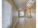 Inviting living room featuring wood floors, a ceiling fan, and elegant lighting at 14623 N 90Th Ln, Peoria, AZ 85381