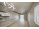 Bright, open-concept living room featuring modern lighting and sliding glass doors at 14623 N 90Th Ln, Peoria, AZ 85381
