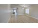 Open-concept living room with wood floors and modern lighting at 14623 N 90Th Ln, Peoria, AZ 85381