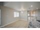 Bright living area with modern lighting and a view into the kitchen, with stainless steel appliances at 14623 N 90Th Ln, Peoria, AZ 85381