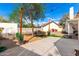 An inviting backyard featuring a concrete patio, string lights, and well-maintained landscaping at 16496 N 68Th Ave, Peoria, AZ 85382