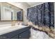Stylish bathroom with updated vanity, framed mirror, and eye-catching shower curtain design at 16496 N 68Th Ave, Peoria, AZ 85382