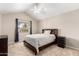 Bedroom with vaulted ceiling, large window, ceiling fan, dark furniture, and carpet floors at 16496 N 68Th Ave, Peoria, AZ 85382