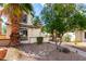 Charming home exterior featuring desert landscaping and a mature palm tree, enhancing curb appeal at 16496 N 68Th Ave, Peoria, AZ 85382