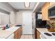 Functional kitchen featuring ample counter space, white appliances, and wooden cabinetry at 16496 N 68Th Ave, Peoria, AZ 85382