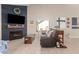 Comfortable living area with a fireplace, TV, and cozy seating, offering a relaxing atmosphere at 16496 N 68Th Ave, Peoria, AZ 85382