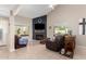 Cozy living room featuring a fireplace, comfortable seating, and natural light, perfect for relaxation at 16496 N 68Th Ave, Peoria, AZ 85382