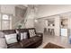 Bright living space with a leather couch, open staircase, and bar area for entertaining at 16496 N 68Th Ave, Peoria, AZ 85382