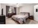 Cozy main bedroom with carpet, ceiling fan, and a dark wood dresser for ample storage space at 16496 N 68Th Ave, Peoria, AZ 85382