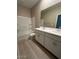 Bathroom with double sinks, a bathtub, and tile floors at 17016 W Cavedale Dr, Surprise, AZ 85387