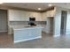 Modern kitchen with white cabinets, an island, and stainless steel appliances at 17016 W Cavedale Dr, Surprise, AZ 85387